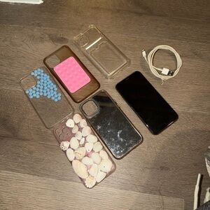 Unlocked IPhone 11 Pro with cases and cable